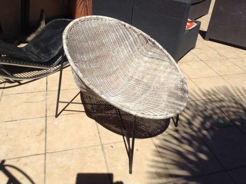 White Wicker lens shaped chair