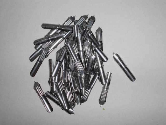 70 unused, dipping pen nibs and one wooden nib holder pen
