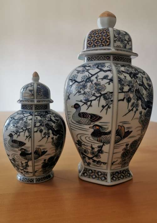 Japanese Meiji style Vases with lids on wooden bases.
