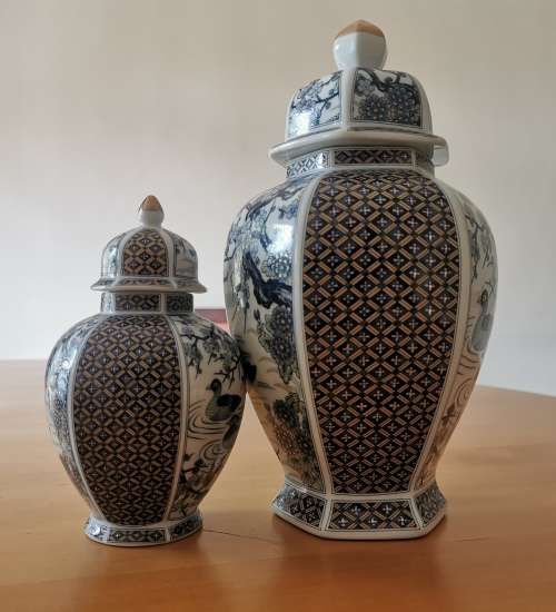 Japanese Meiji style Vases with lids on wooden bases.