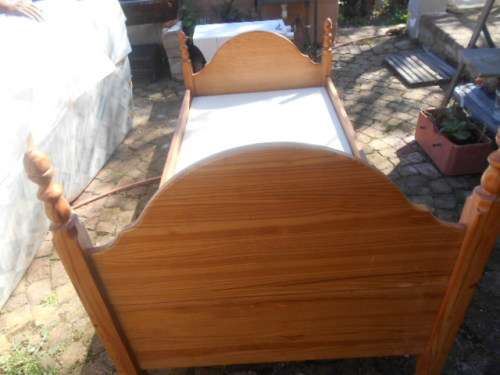 Single pine high foot and low end bed frame with 2 good condition mattresses