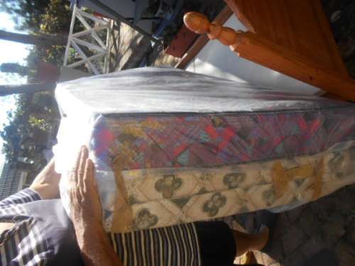 Single pine high foot and low end bed frame with 2 good condition mattresses