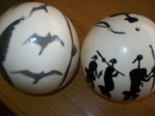 SET OF TWO  OSTRICH EGGS DECORATED WITH AFRICAN MOTIVES ON STANDS