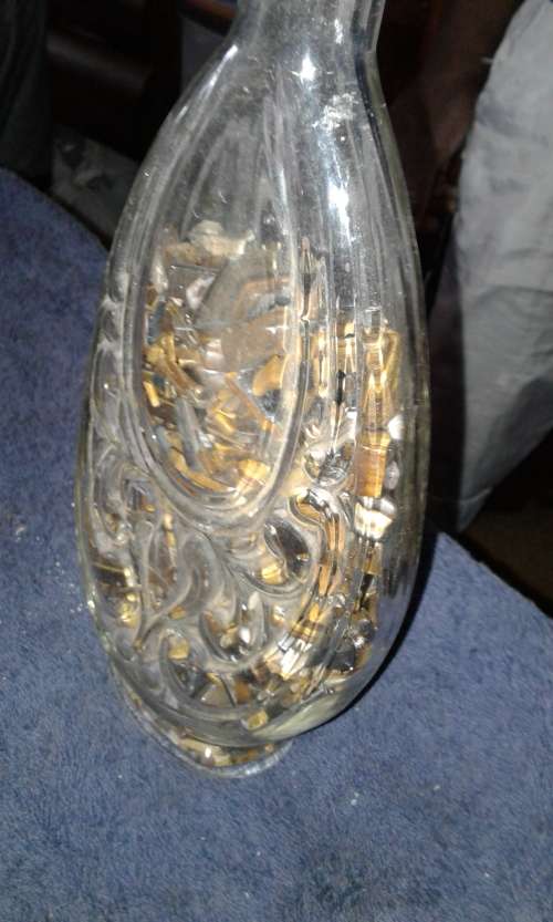 bottle with tiger eye stones in it