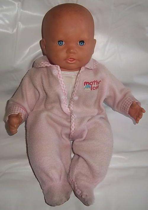 A DOLL WITH PINK OUTFIT, MAKES SOUNDS, EYES OPENS AND CLOSES