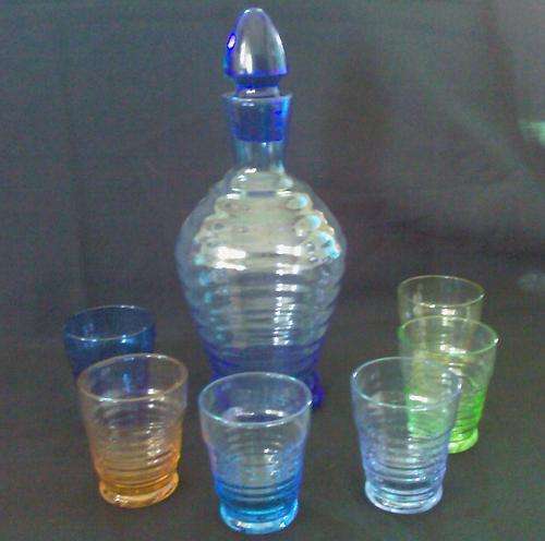 A STUNNING COLOURED GLASS DECANTER WITH X6 SHOT GLASSES