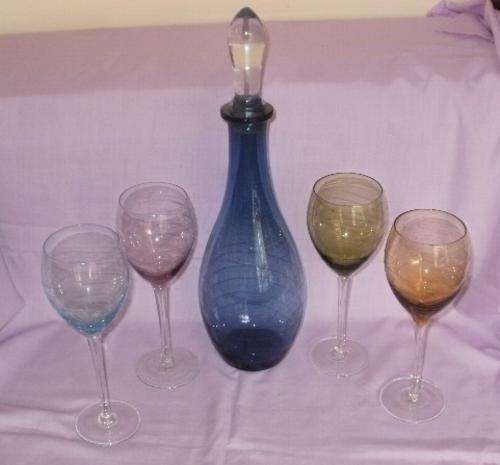 A COLOURED WINE DECANTER AND X4 WINE GLASSES