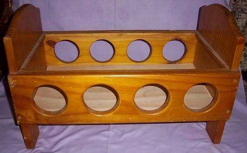 A VINTAGE WOODEN DOLLS COT