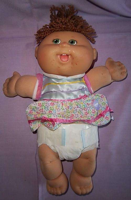A CABBAGE PATCH DOLL WITH ORIGINAL CLOTHS, SIGNED ON THE BUM