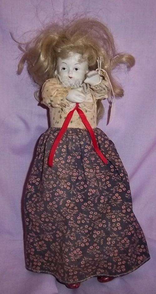 A VINTAGE STYLE PORCELAIN DOLL