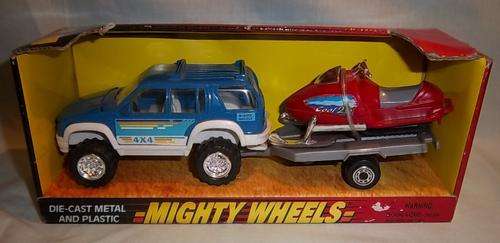 A BOXED MIGHTY WHEELS 4X4 WITH TRAILER AND SNOWMOBILE