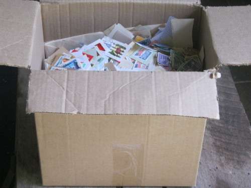 BOX OF STAMPS ON PAPER - MIXED WORLD BUT MAINLY SOUTH AFRICA