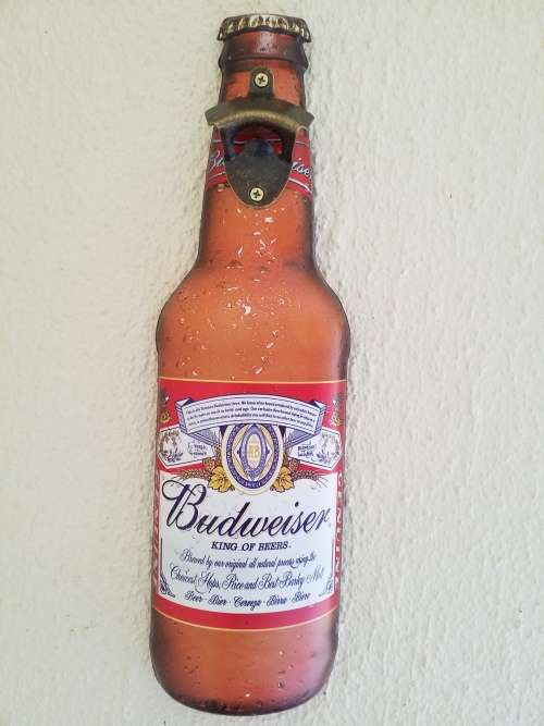 `BUDWEISER` THEMED, (X- LARGE) DECORATIVE EMBOSSED METAL HANGING SIGN WITH BOTTLE OPENER  - NEW
