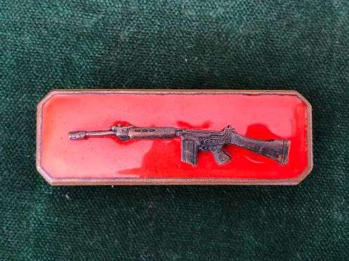 SA ARMY MARKSMAN BADGE-BLACKENED BRONZE RIFLE ON RED ENAMEL BACKING-2 PIECE- 2 PINS