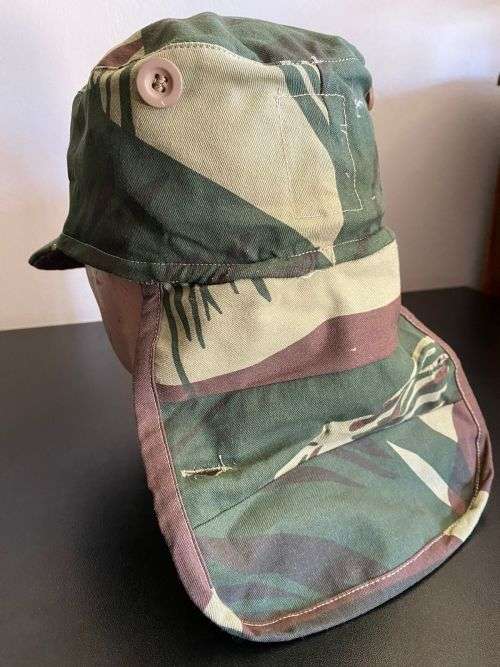 REPRODUCTION RHODESIAN CAMO FLAP CAP-SIZE XL INSIDE RING MEASURES 55CM-LABELLED AND DATED BY NIENMOL