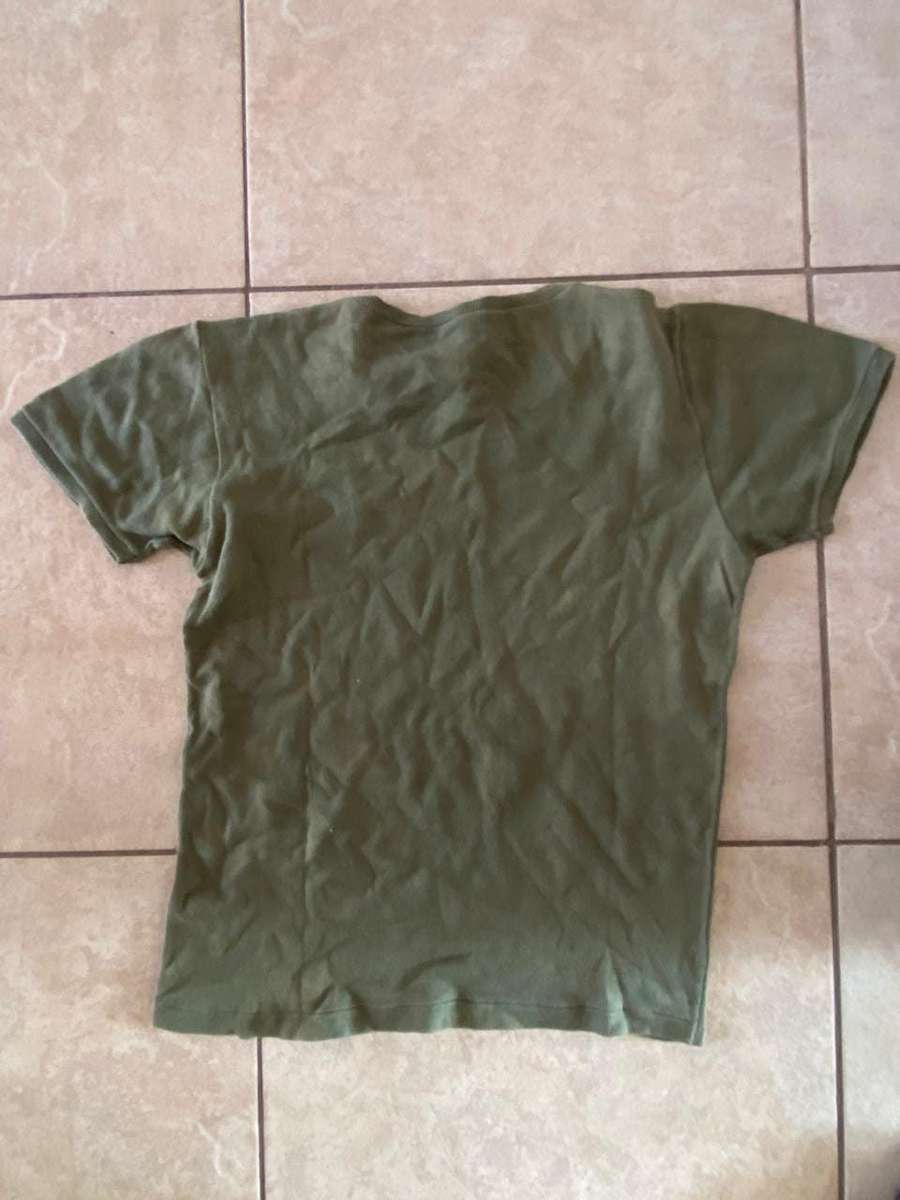 RHODESIAN T SHIRT-A SIZE MEDIUM- USED BUT GOOD-PEN MARKED-RAY WILSON