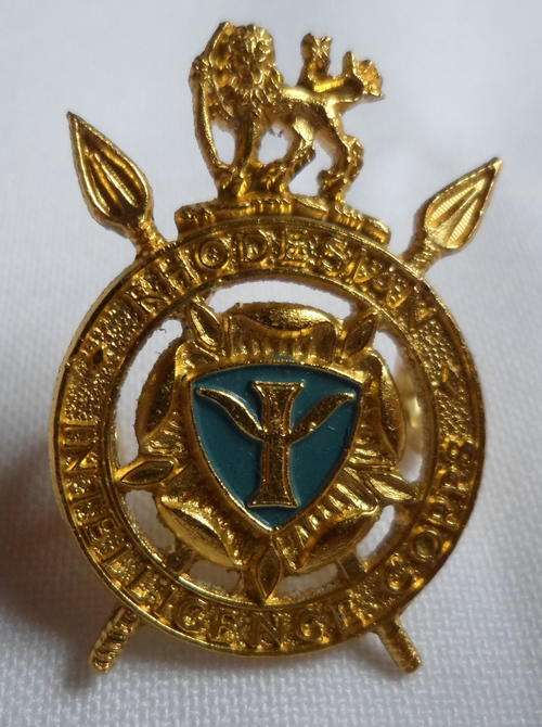 RHODESIA INTELLIGENCE CORPS GOLD ANODISED CAP BADGE-WORN 1977-80- 2 LUGS