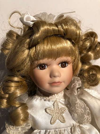 Porcelain collectible doll with certificate of authenticity.