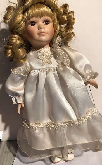 Porcelain collectible doll with certificate of authenticity.