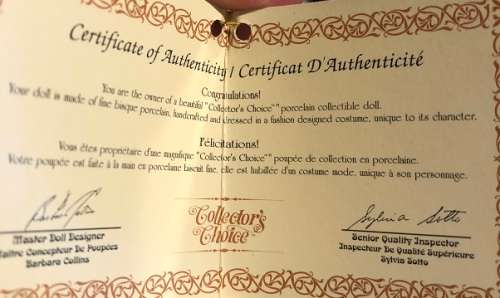 Porcelain collectible doll with certificate of authenticity.