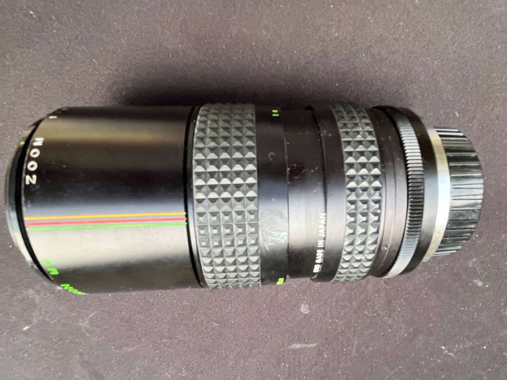 MAKINON zoom lense and MINOLTA film camera.