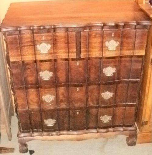 A IMBUIA BALL AND CLAW CHEST OF DRAWERS