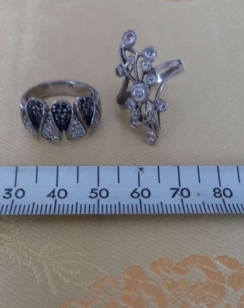 TWO STERLING SILVER RINGS SET WITH BLACK AND WHITE CZ STONES