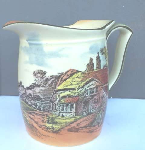 RARE .... Royal Doulton series ware milk jar  decorated with cottage scenes against a lemon yellow