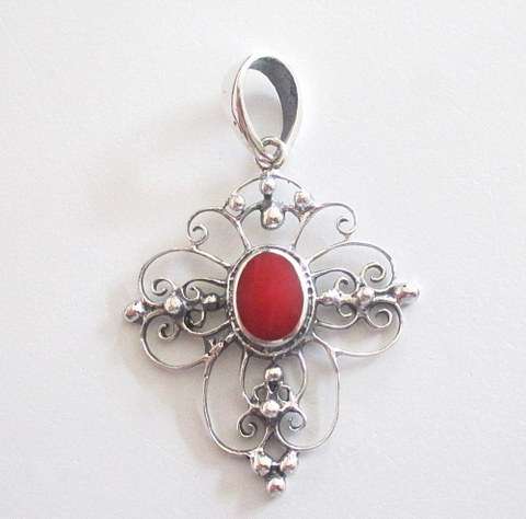 A SOLID SILVER CROSS PENDANT WITH A SIMULATED RED CORAL STONE