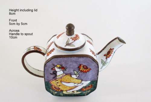 A SMALL ENAMEL AND METAL TEAPOT
