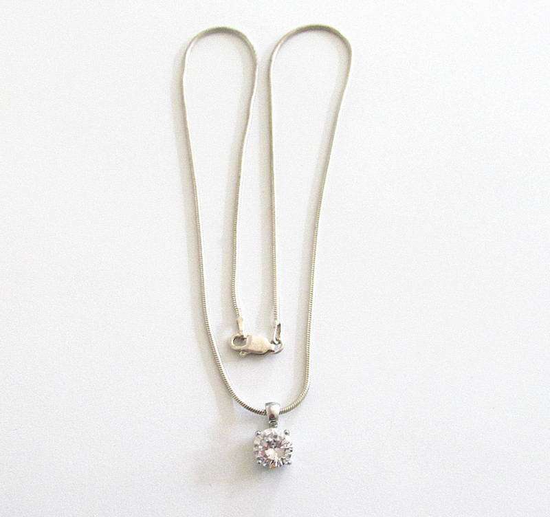 A SOLID SILVER PENDANT ON A SILVER SNAKE CHAIN PLUS SIMILAR PLATED EARRINGS