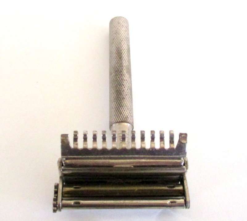 AN AUTO  STROP SAFETY RAZOR WITH BLADES AND A HAIR CUTTER