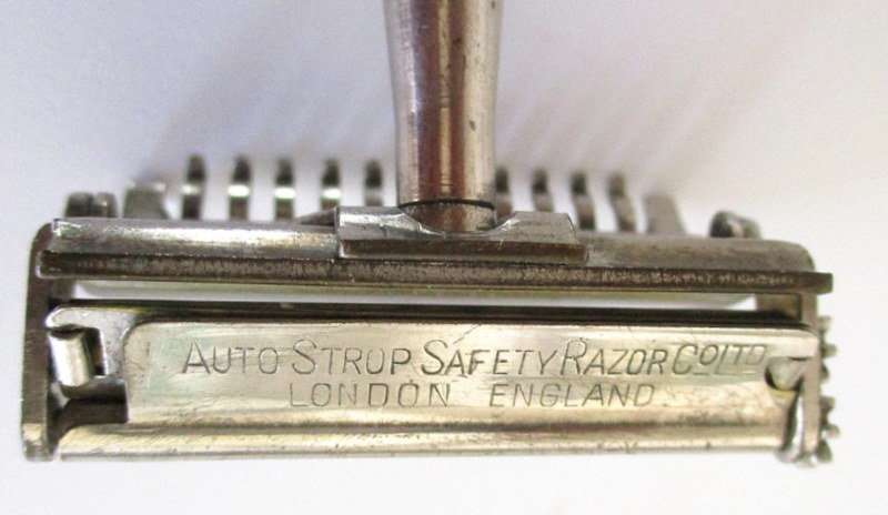 AN AUTO  STROP SAFETY RAZOR WITH BLADES AND A HAIR CUTTER