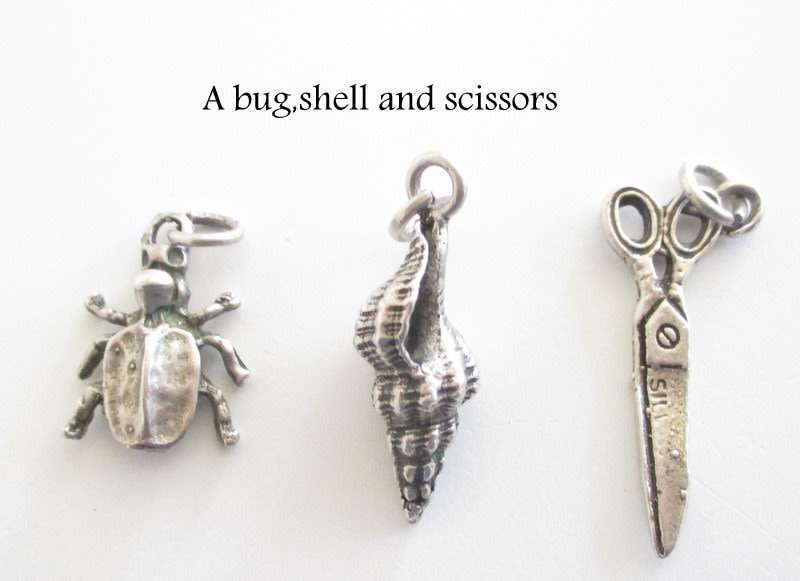 A LOT OF SOLID SILVER CHARMS---23,6 Gram