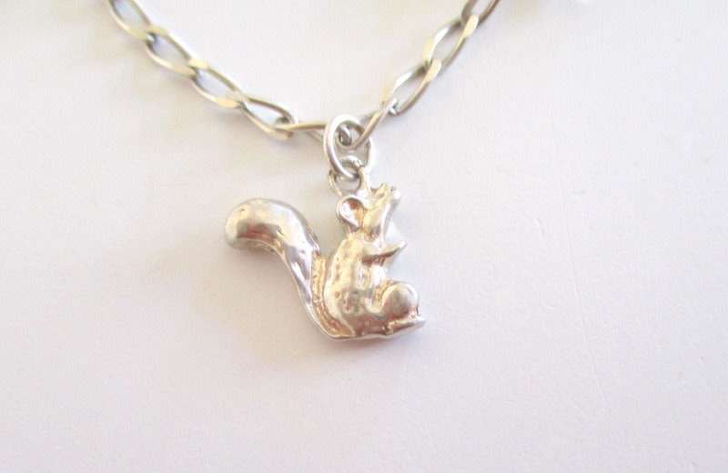 A SOLID SILVER CHARM BRACELET