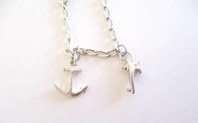 A SOLID SILVER CHARM BRACELET
