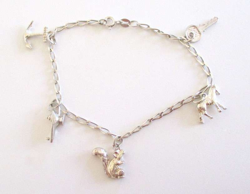 A SOLID SILVER CHARM BRACELET