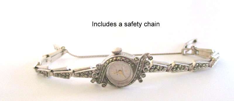 A STERLING SILVER MARCASITE (ALL INTACT) WATCH IN WORKING ORDER AND KEEPING TIME