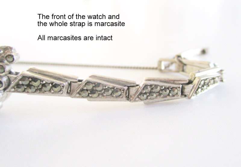A STERLING SILVER MARCASITE (ALL INTACT) WATCH IN WORKING ORDER AND KEEPING TIME