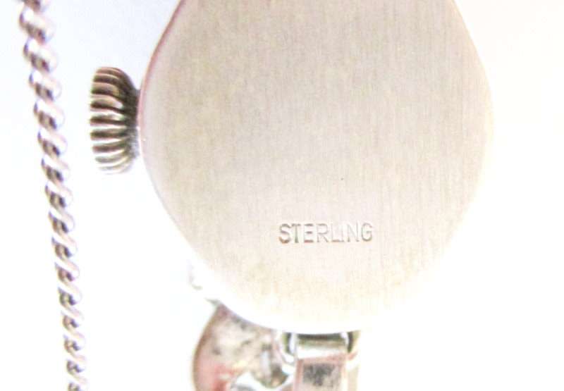 A STERLING SILVER MARCASITE (ALL INTACT) WATCH IN WORKING ORDER AND KEEPING TIME