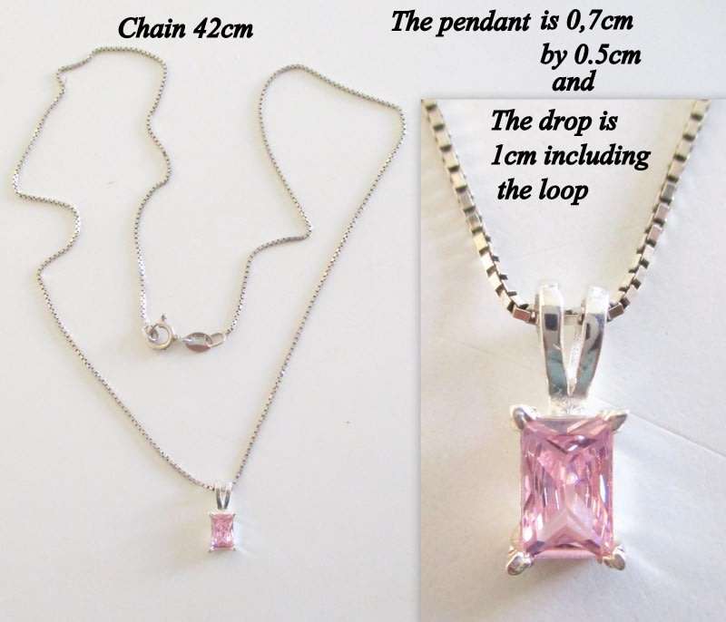 A DAINTY SOLID SILVER PENDANT WITH A PINK STONE ON A SILVER CHAIN