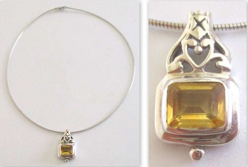 A STERLING SILVER PENDANT ON A STIFF STERLING SILVER CHAIN