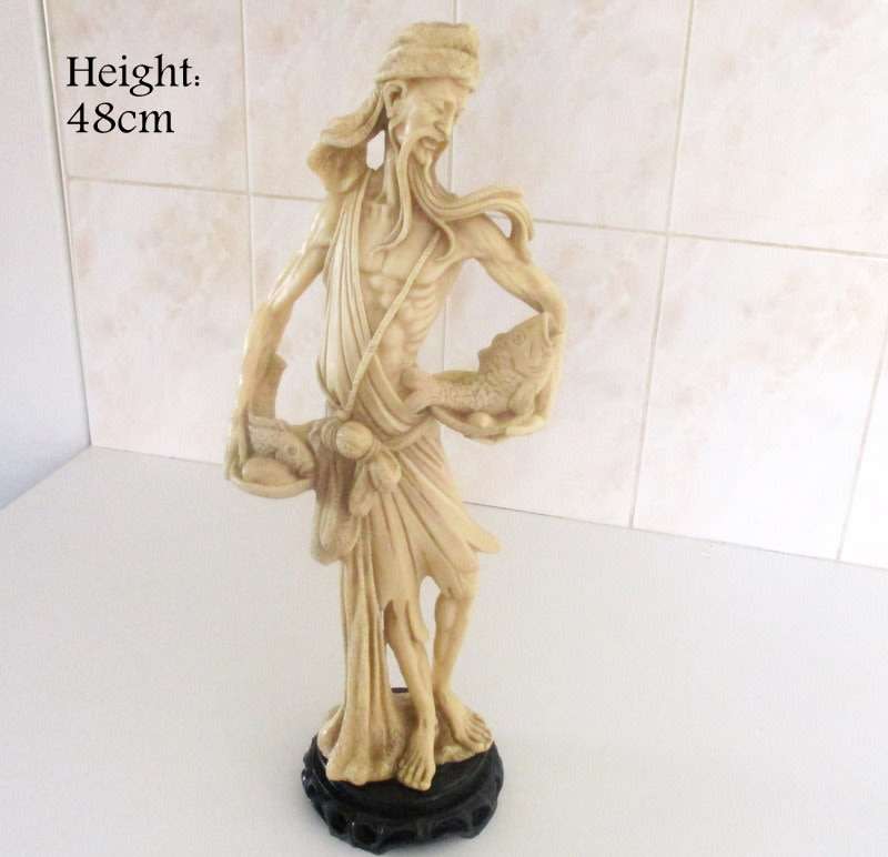 A LARGE ORIENTAL FIGURE OF A FISHERMAN---Signed