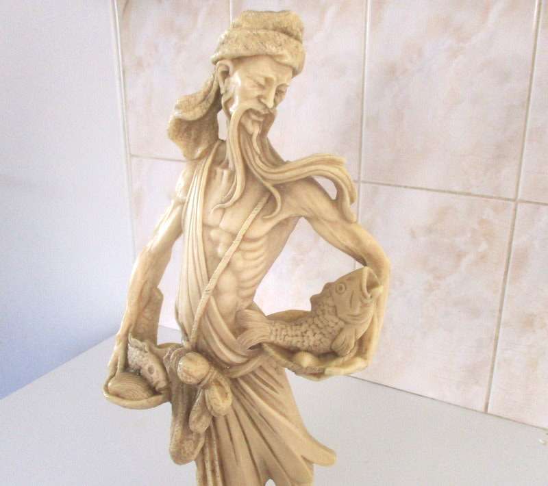 A LARGE ORIENTAL FIGURE OF A FISHERMAN---Signed