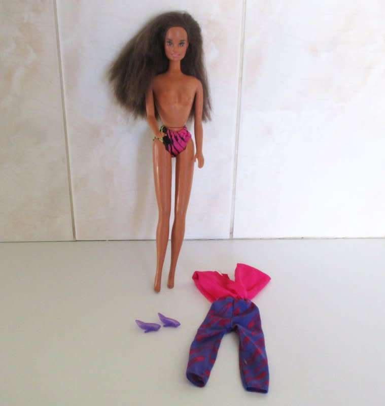A 1990 Barbie doll with original barbie dress