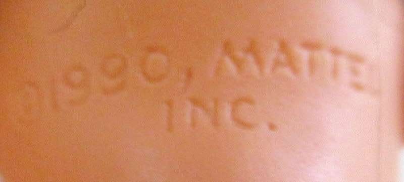 A 1990 Barbie doll with original barbie dress