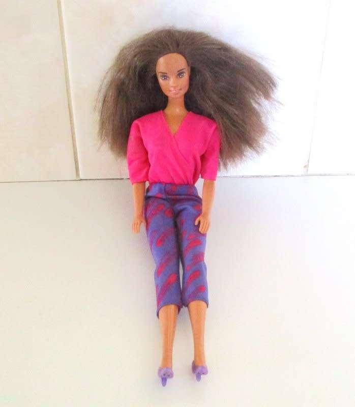 A 1990 Barbie doll with original barbie dress