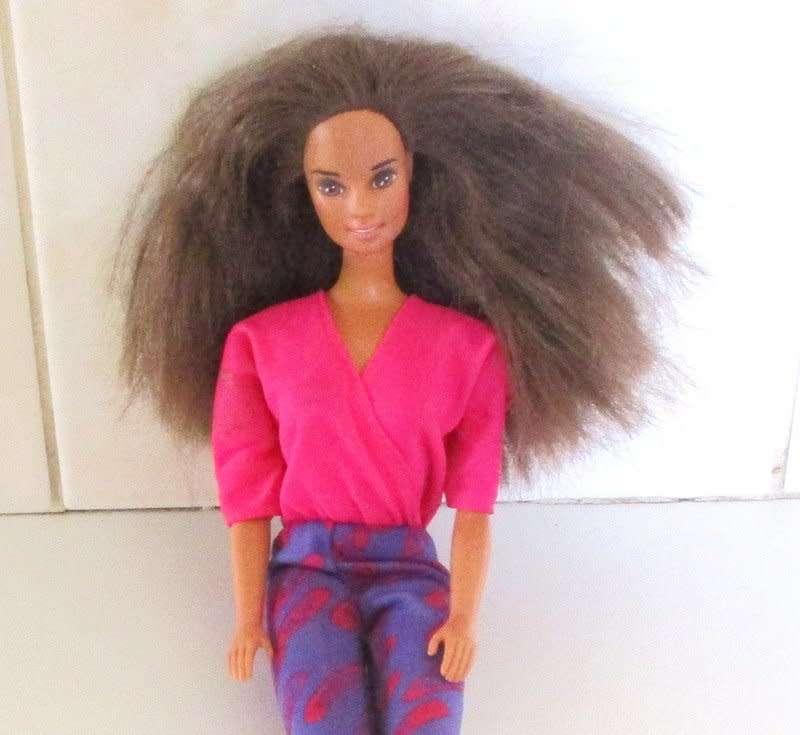 A 1990 Barbie doll with original barbie dress
