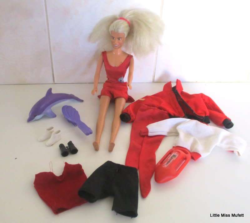 A VINTAGE 1997 BAYWATCH BARBIE DOLL WITH SOME ORIGINAL CLOTHES AND OTHER CLOTHES AND ACCESSORIES