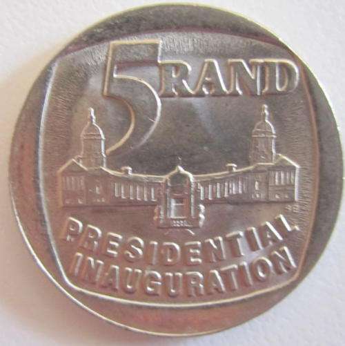 AN UCIRCULATED 1994 INAUGURATION COIN-